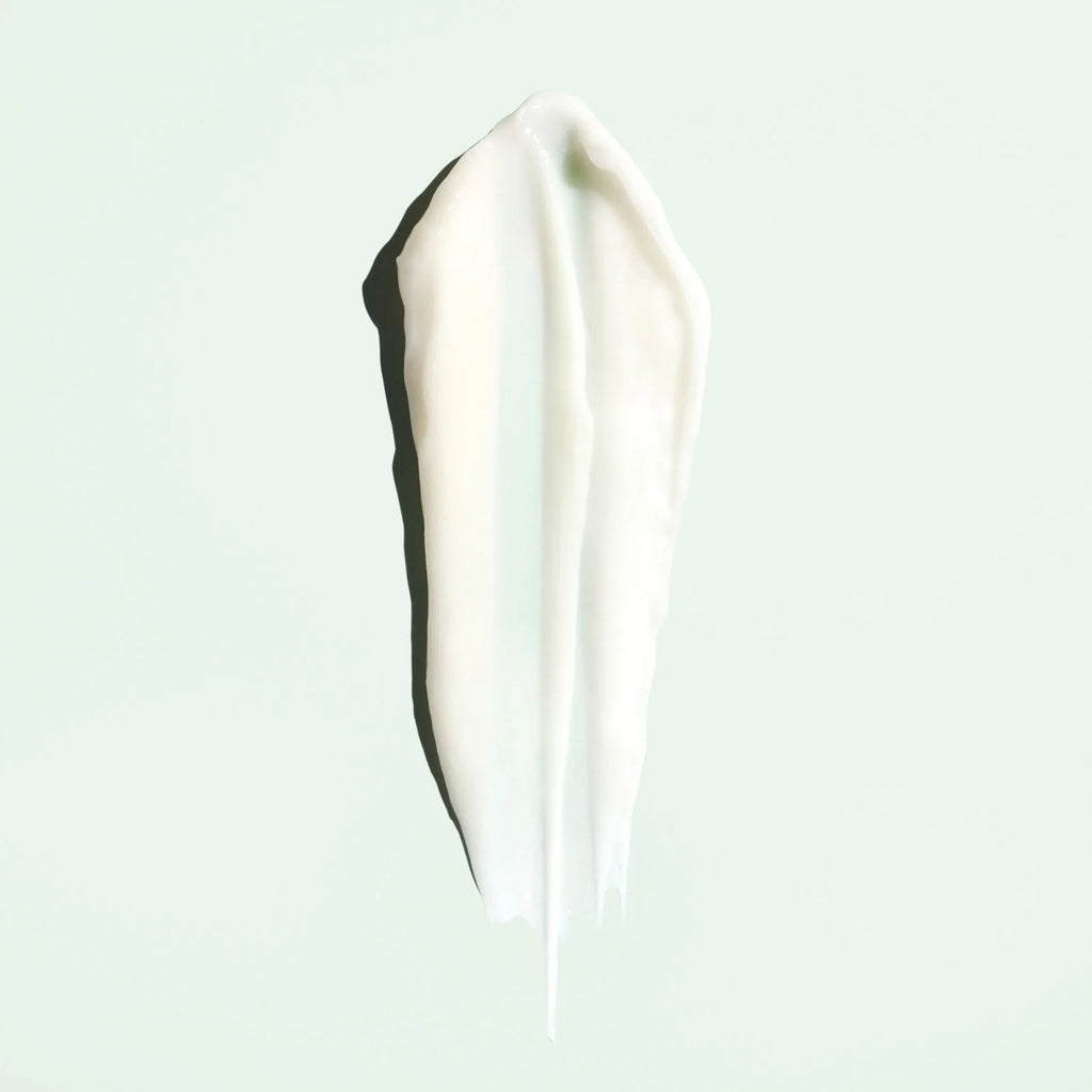 White cream smear on a light blue background