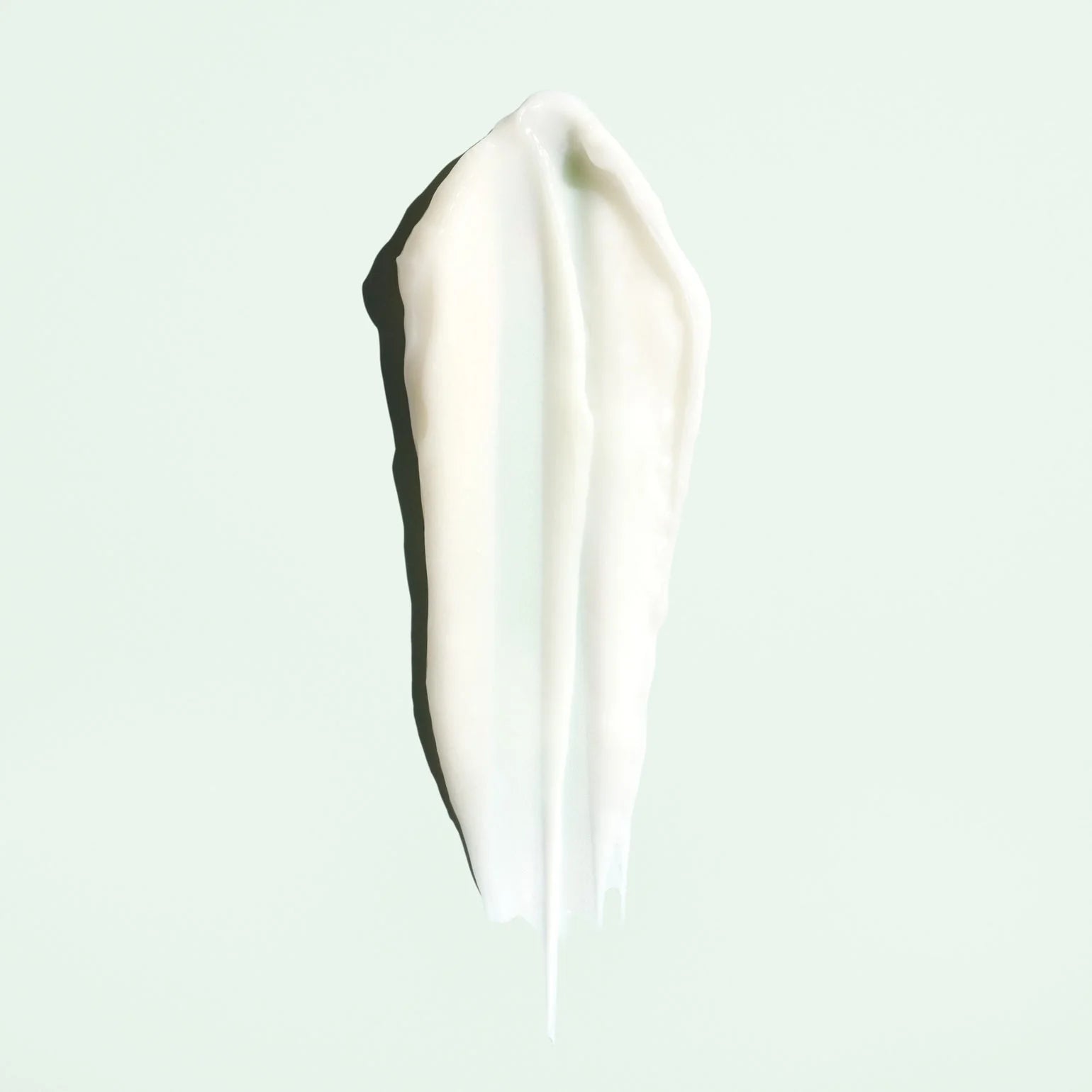 White cream smear on a light blue background