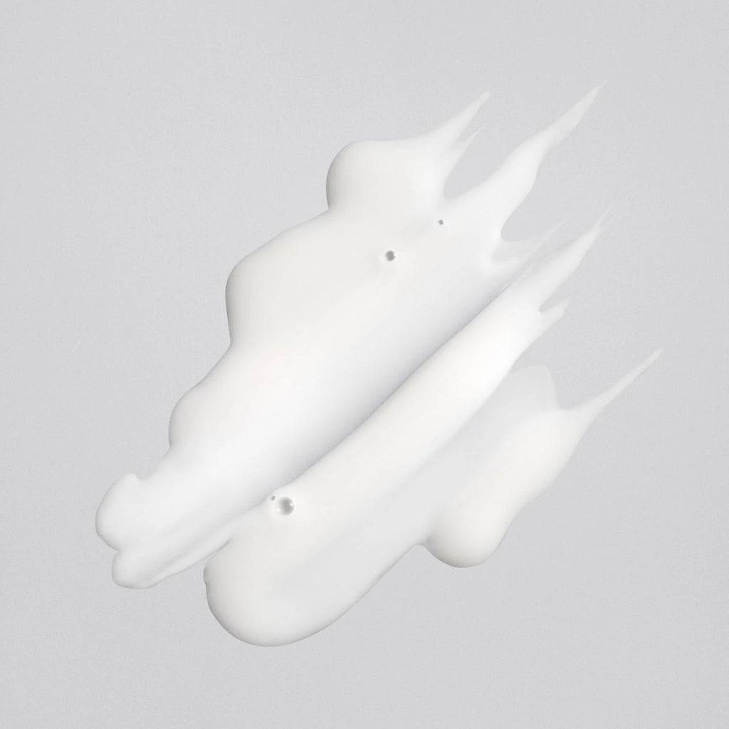 White liquid droplet on a gray background