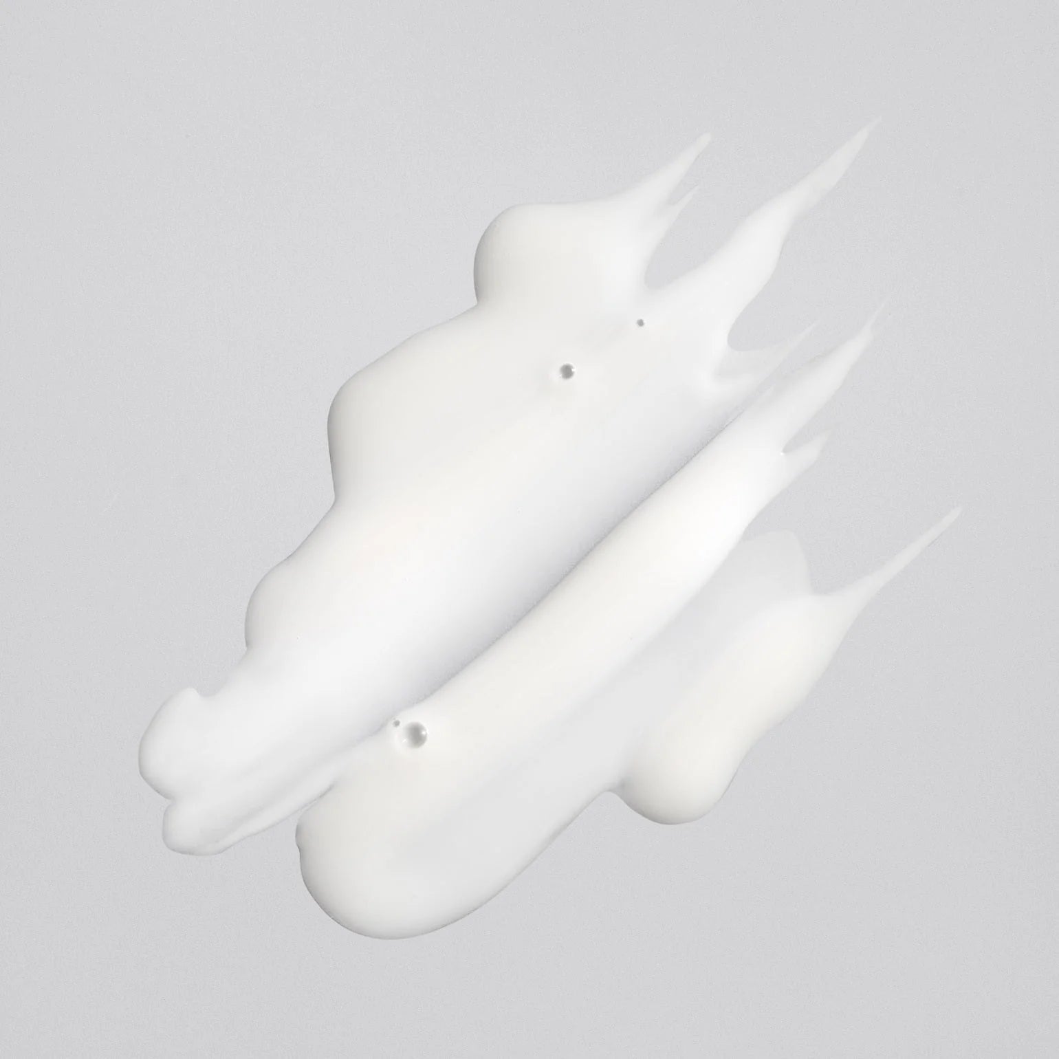 White liquid droplet on a gray background