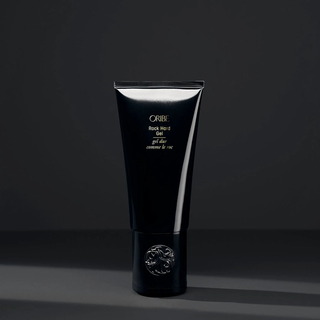 Black tube of Oribe hair product on a dark background