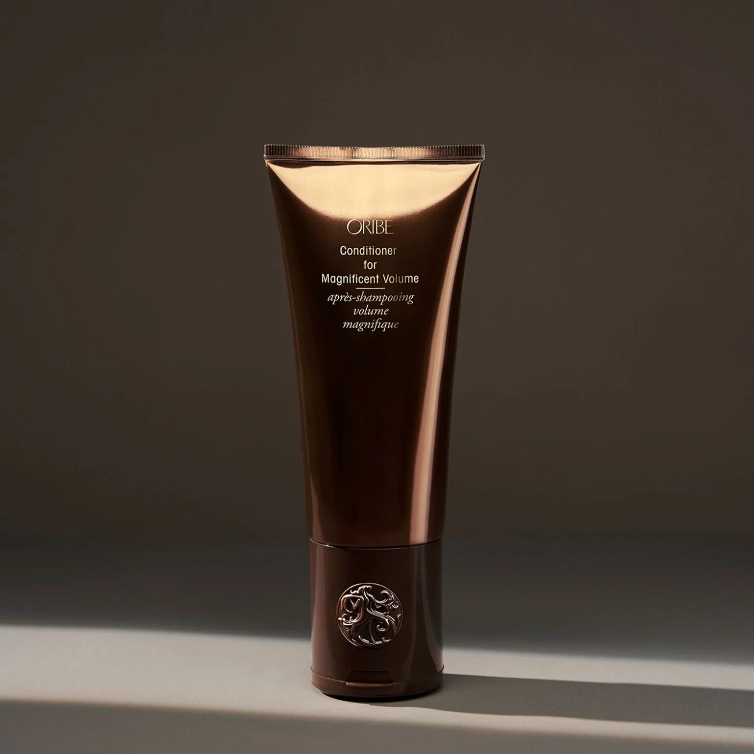 Oribe conditioner tube for magnificent volume on a dark background