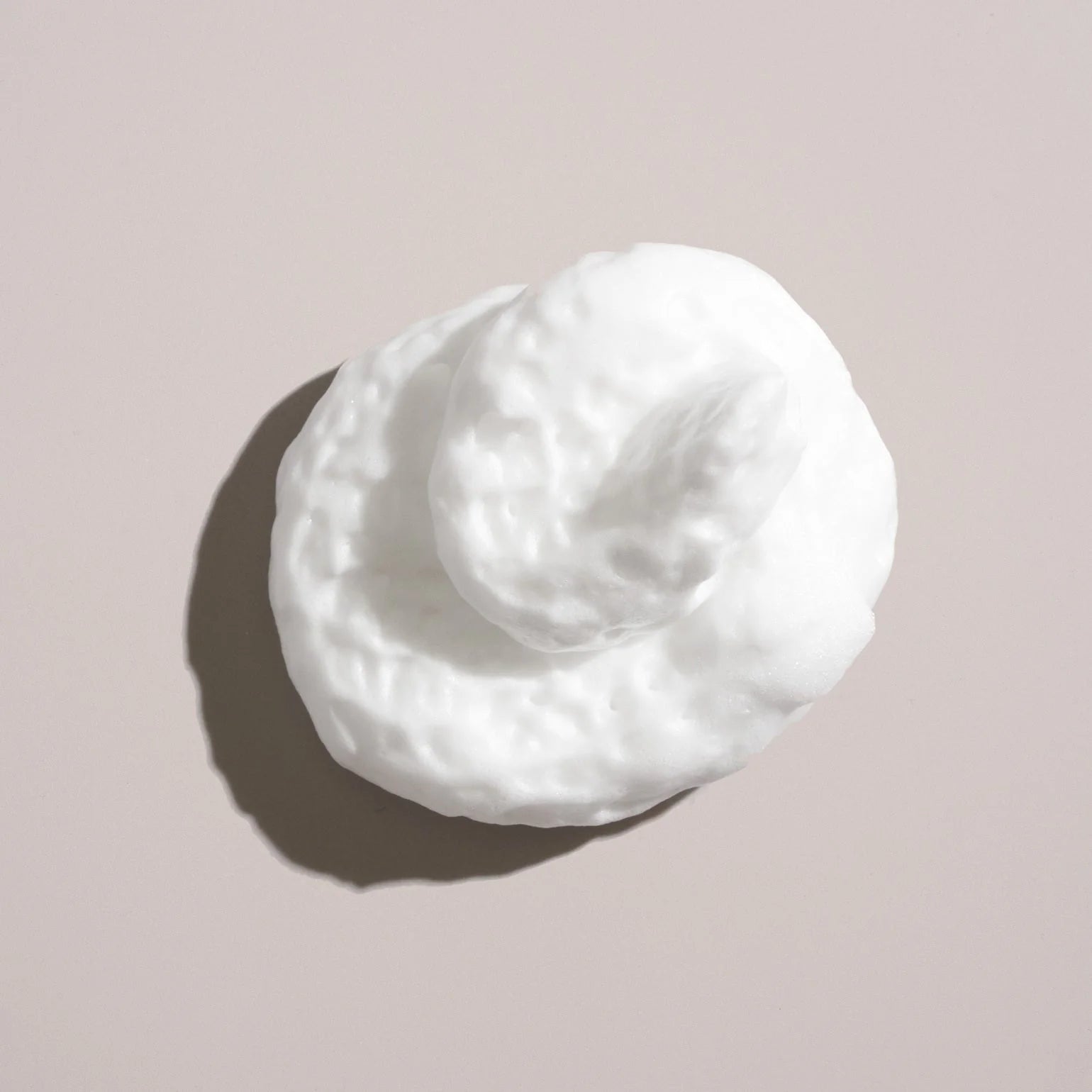 White cream puff on a beige background