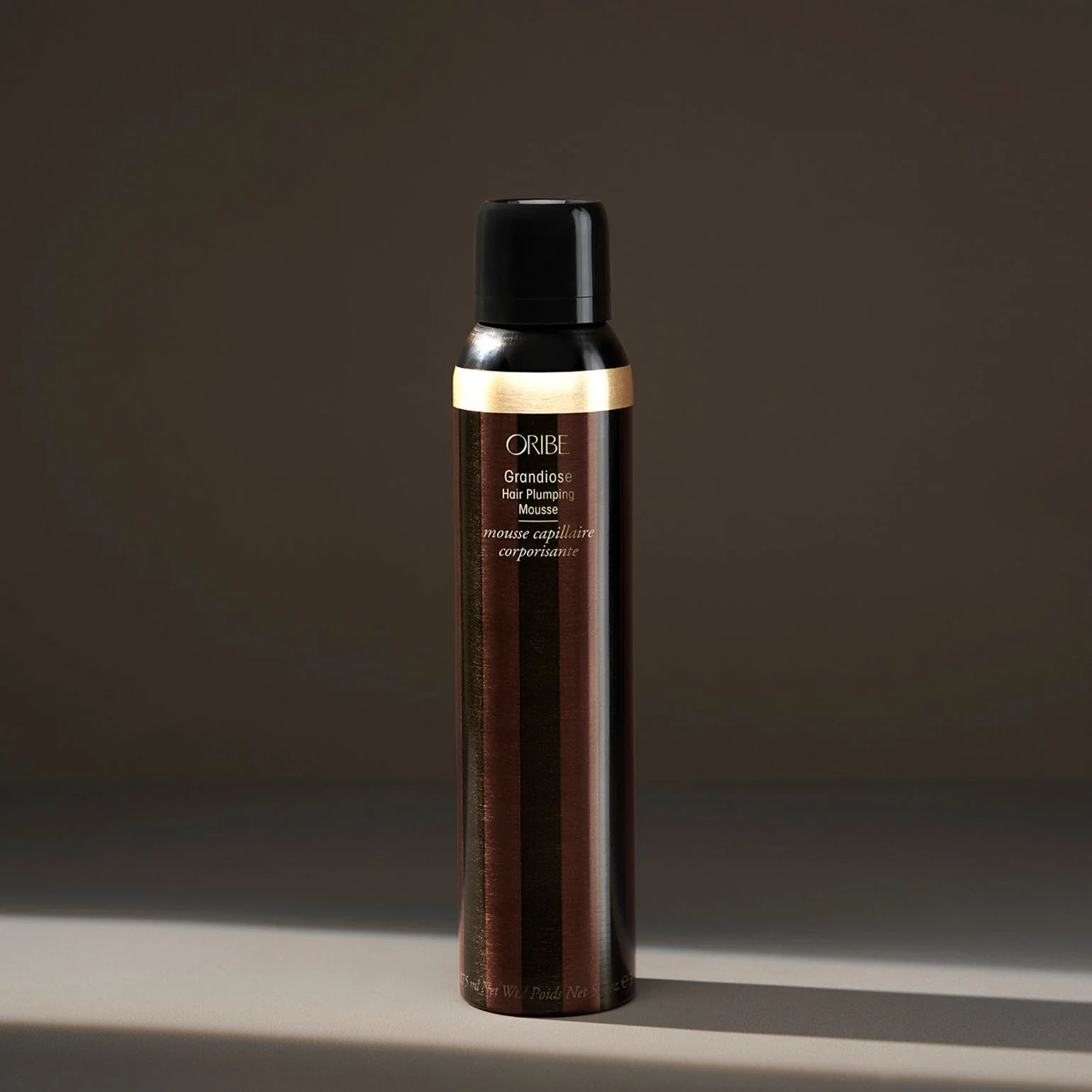 Oribe hair product bottle on a dark background