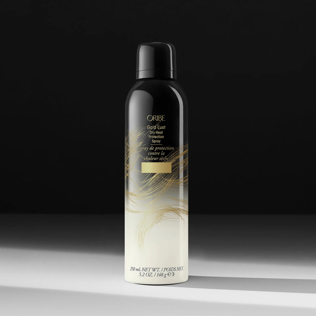 Oribe Gold Lust Dry Texturizing Spray bottle on a dark background