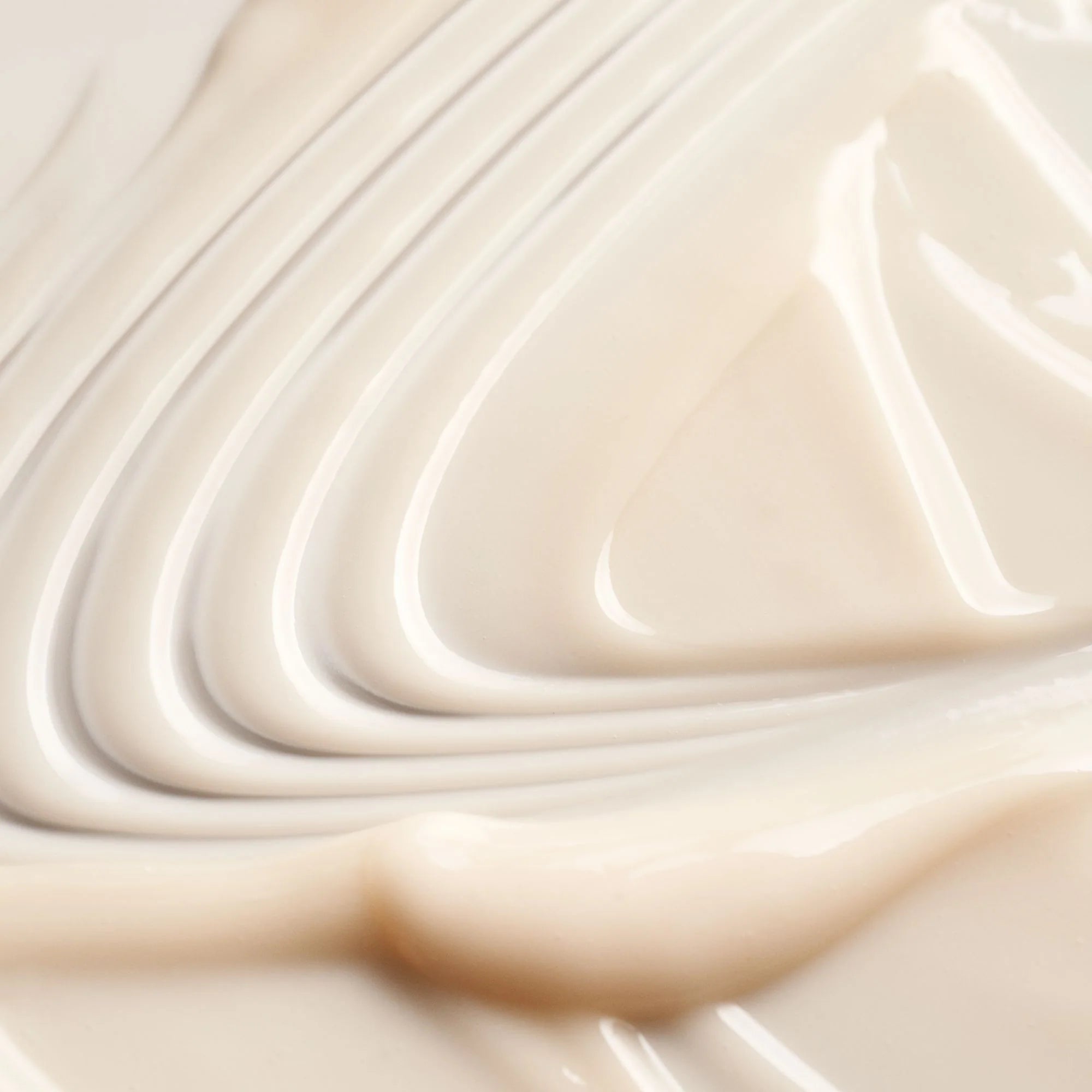 Close-up of smooth, beige cream with wavy patterns