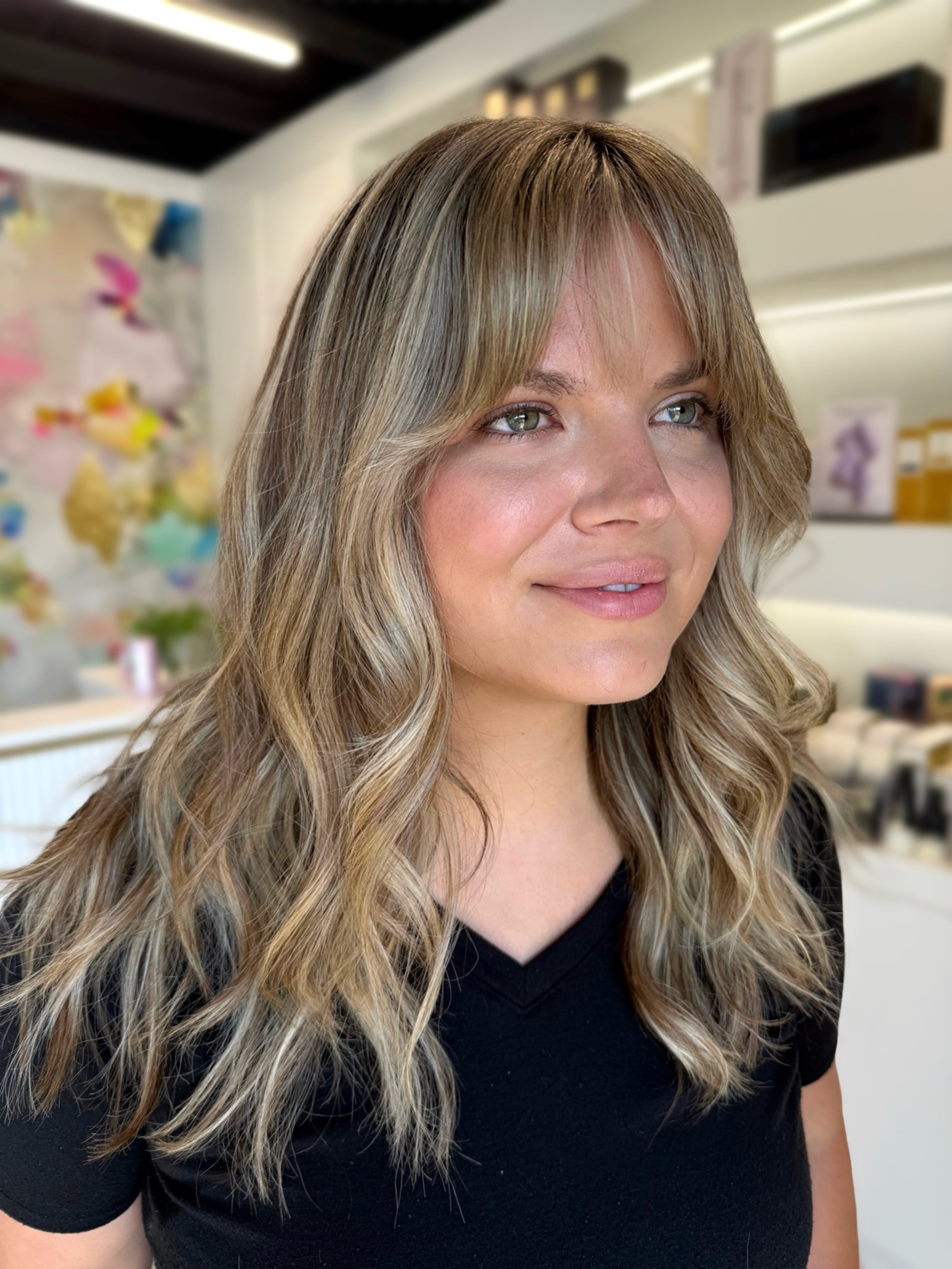 Woman with styled hair in a salon setting