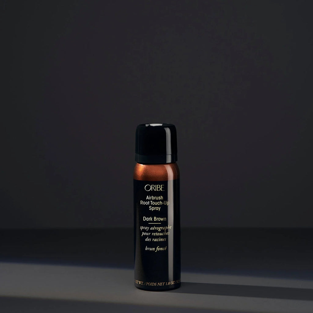 Oribe hair product bottle on a dark background