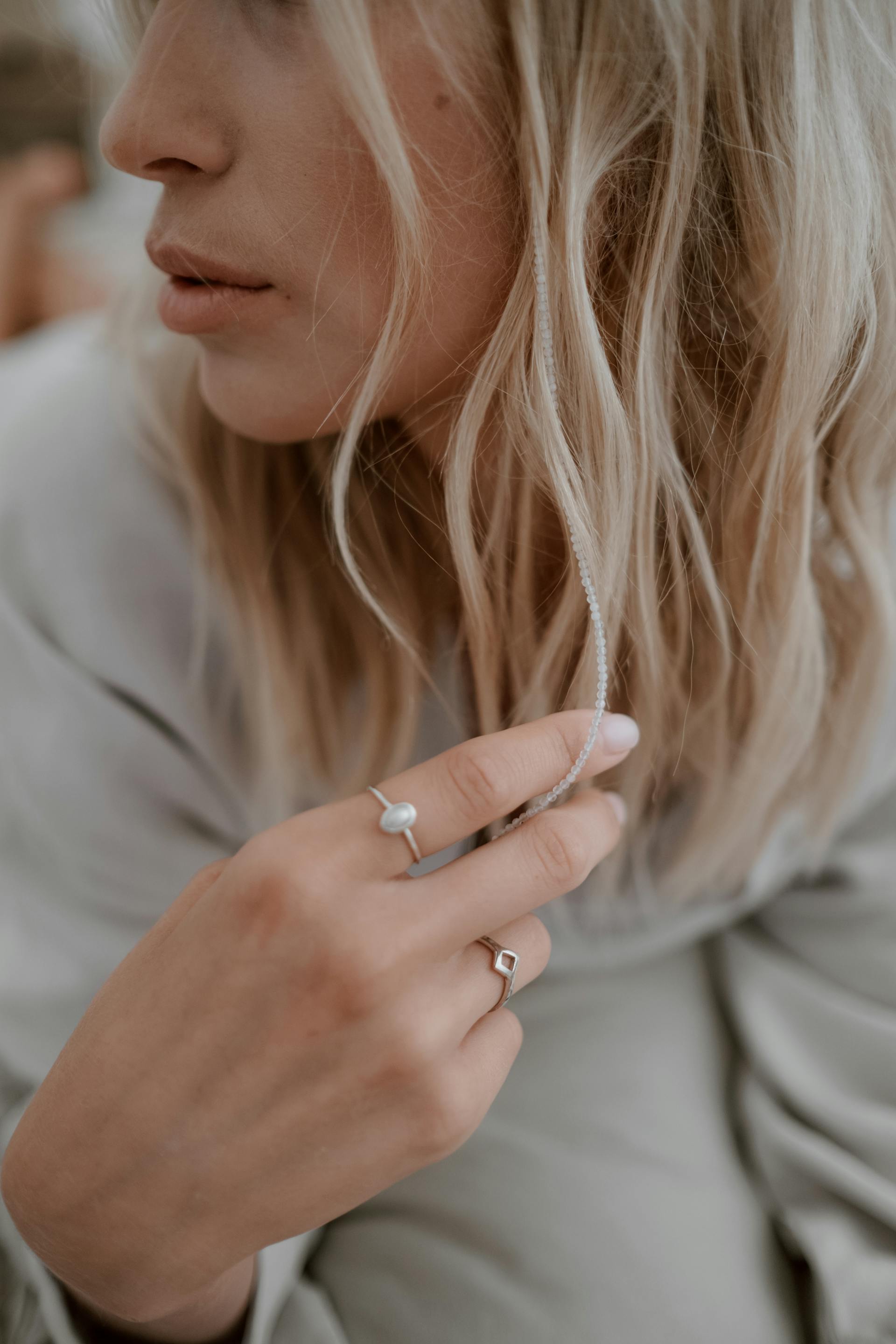 Close-up of a person wearing rings with a blurred background